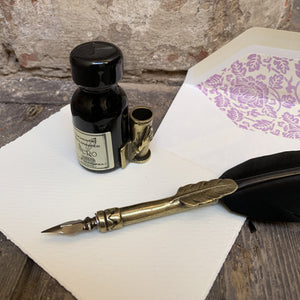 Feather dip pen with ink