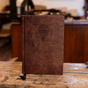 Handcrafted small leather journal featuring embossed logo of hot air ballonn saying 'Time to Travel More'