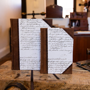 Two handcrafted SB Libris half leather journals in large and small sizes, combining brown goatskin with antique script paper.