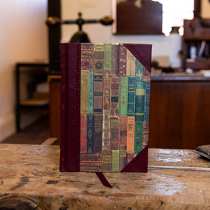 Front cover of the small Library Books half leather journal by SB Libris, bound in burgundy leather with a richly detailed book spine print.