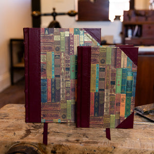Set of two SB Libris handbound half leather journals with burgundy spines and printed paper covers inspired by antique book spines.