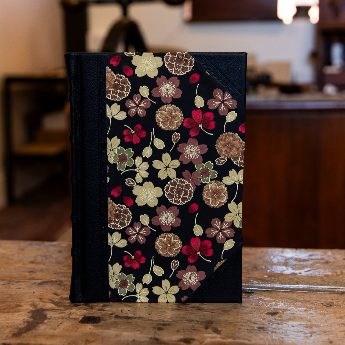 Small SB Libris handbound journal with Japanese floral cover design and traditional black leather corners and spine.