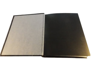 Open view of black leather album showing interleaving tissue