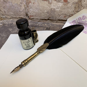 Black feather dip pen with small ink